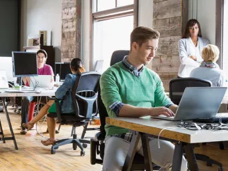 Office workers using PCs at desks